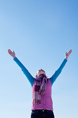 Image showing Teen girl staying with raised hands