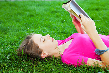 Image showing Teen girl reading the Bible outdoors