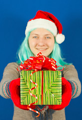 Image showing Teen girl holds a Christmas present