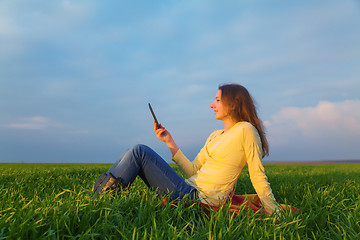 Image showing Teen girl reading electronic book