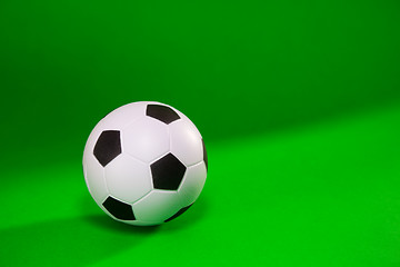Image showing Small soccer ball over green background