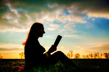 Image showing Teen girl reading book outdoors