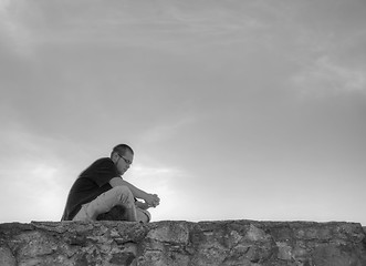 Image showing Young man sittting outdoors