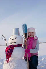 Image showing Teenage girl with snowman