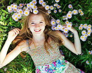Image showing Teen girl lying in grass