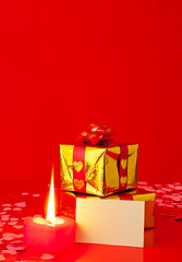 Image showing Presents and burning heart shaped candle with blank card