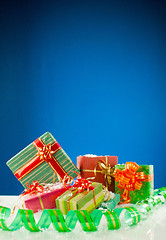 Image showing Christmas presents against blue background