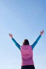 Image showing Teen girl staying with raised hands