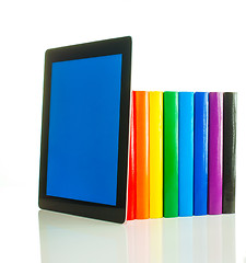 Image showing Row of colorful books and tablet PC