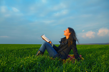 Image showing Teen girl reading the Bible outdoors