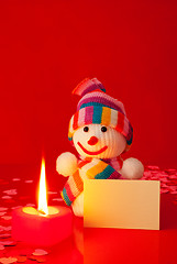 Image showing Snowman with burning heart shaped candle