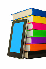 Image showing Stack of colorful books and tablet PC