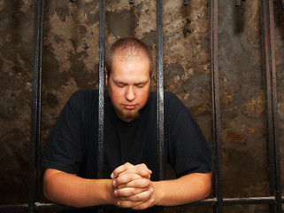 Image showing Young man behind the bars