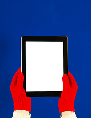 Image showing Hands wearing red gloves holding a tablet PC