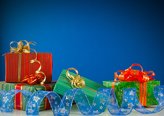 Image showing Christmas presents against blue background