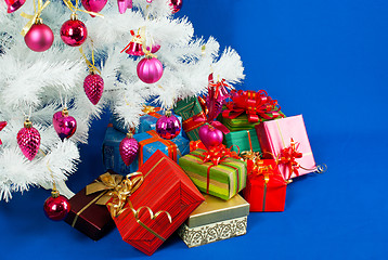 Image showing Heap of the Christmas presents under decorated white evergreen t