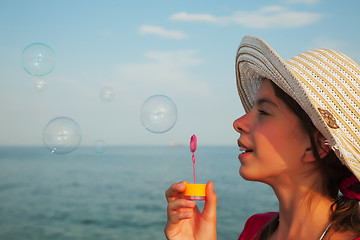 Image showing Teen girl blowing bubbles