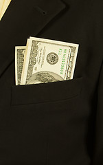 Image showing Close-up of businessman with dollar banknotes in pocket