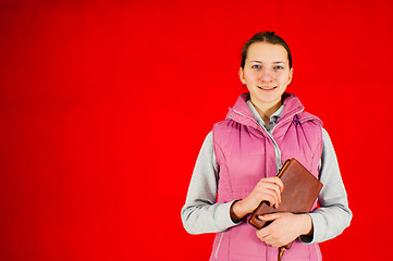 Image showing Teen girl staying with a book