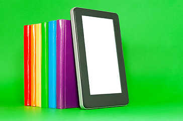 Image showing Row of colorful books and tablet PC