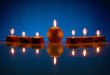 Image showing Seven burning candles over blue background