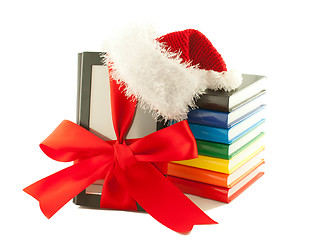 Image showing Electronic book reader wearing Santa's hat with stack of books