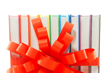 Image showing Row of colorful books tied up with ribbon