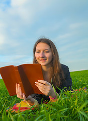 Image showing Teen girl reading the Bible outdoors