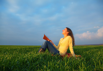 Image showing Teen girl reading the Bible outdoors