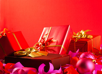 Image showing Christmas gifts over red background