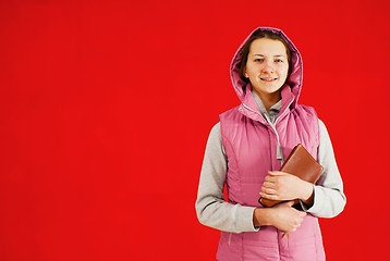 Image showing Teen girl staying with a book