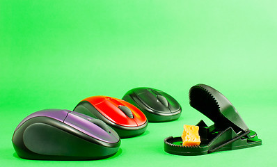 Image showing Three computer mouses with a mousetrap
