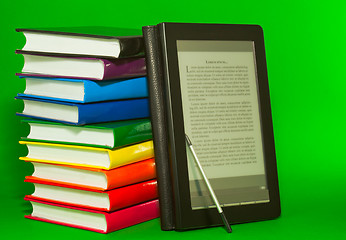 Image showing E-book reader with stack of printed books