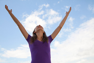 Image showing Young woman sitting with raised hand