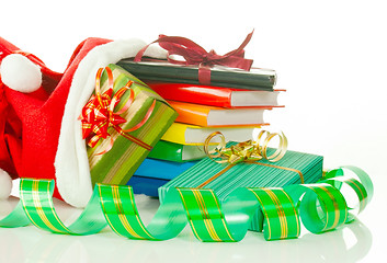 Image showing Christmas presents with e-book reader and books in bag against white background