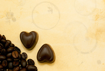 Image showing Two heart shaped chocolate candies and coffee beans