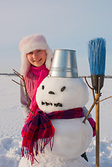 Image showing Teenage girl with snowman