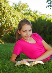 Image showing Teen girl reading the Bible outdoors