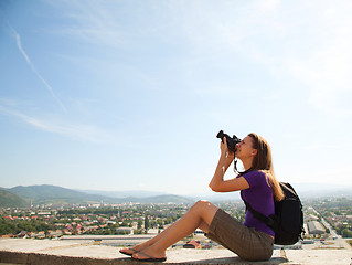Image showing Young lady photographer outdoors