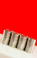 Image showing Coins stacked in bars against red background