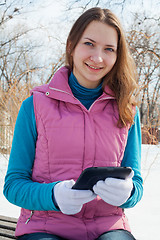 Image showing Teen girl with e-book reader in a park