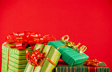 Image showing Wrapped boxes with presents against red background