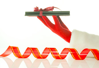 Image showing Hand in red glove holds electronic book reader against white background