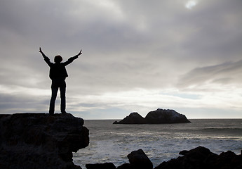 Image showing Woman staying with raised hands