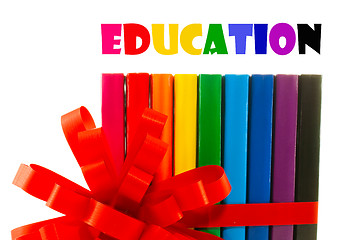 Image showing Row of colorful books tied up with ribbon