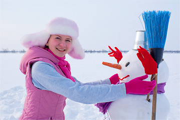 Image showing Teenage girl with snowman