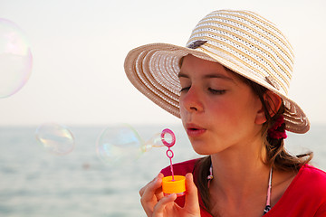 Image showing Teen girl blowing bubbles