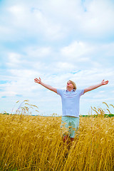 Image showing Young man staying with raised hands