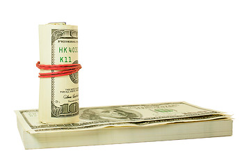 Image showing Roll of US dollars tied up with rubber on the stack of bills