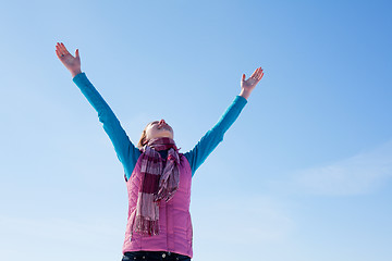 Image showing Teen girl staying with raised hands